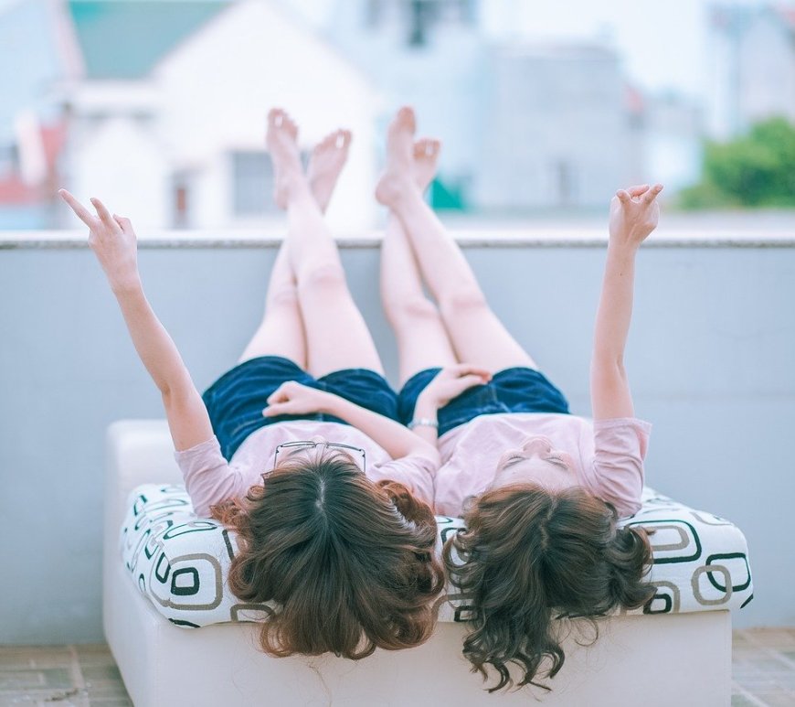 twins on a rooftop lying down